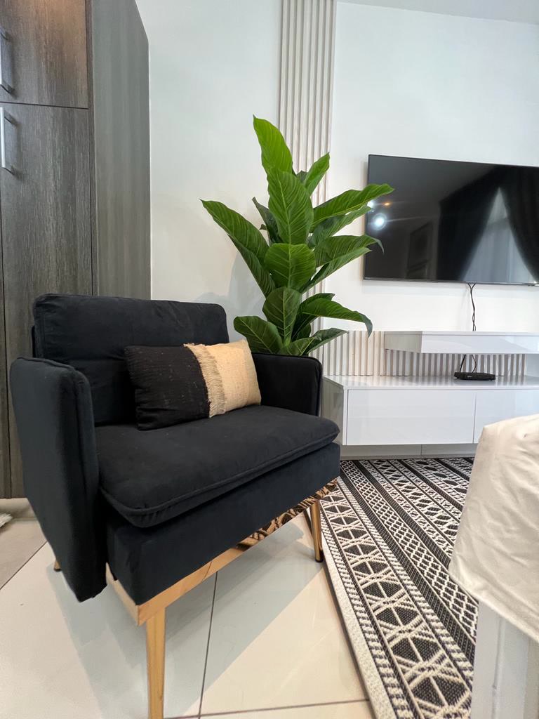 Studio living area with armchair — Studio | Embassy Gardens