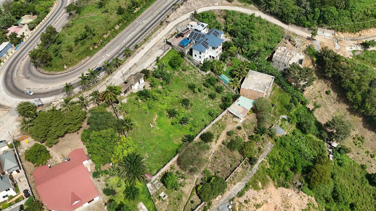 Aerial view of land, boundary walls and buildings in Peduase, Ghana
