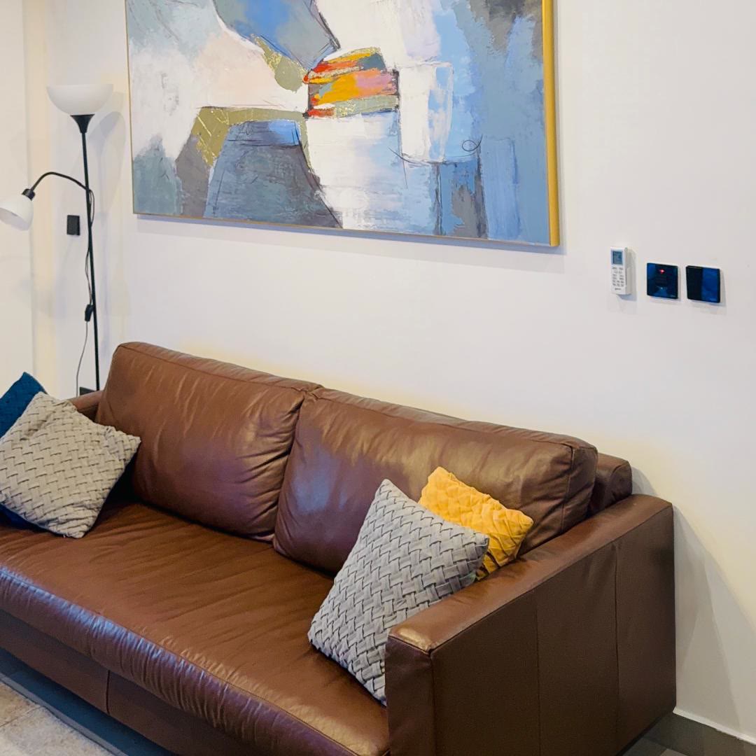 Living room with leather sofa and curated artwork