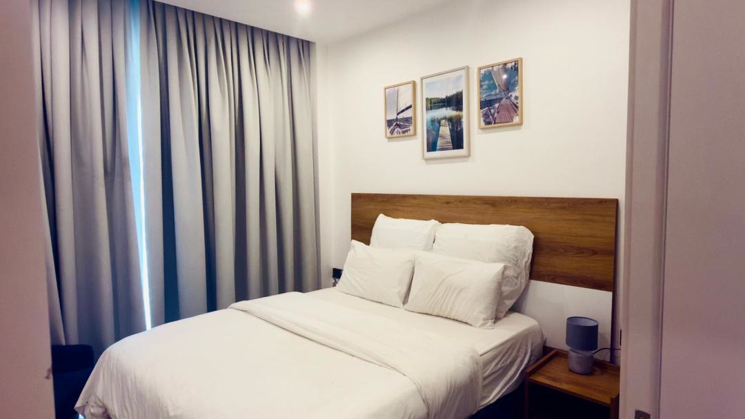 Bedroom with queen bed and blackout curtains